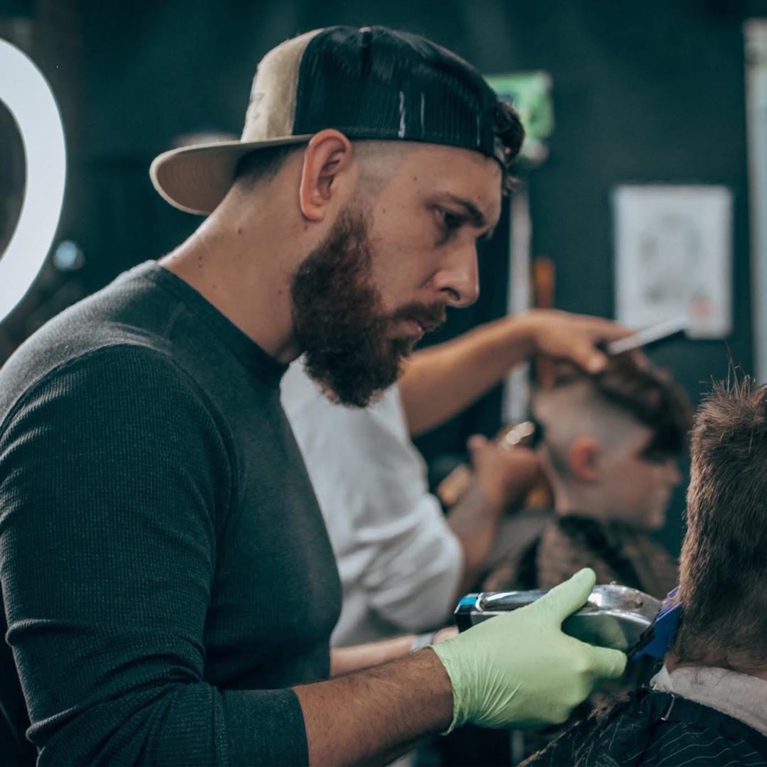 Justin cutting hair with clippers in the studio